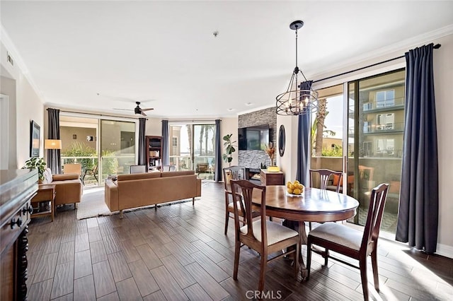 1500 E Ocean Blvd Unit 419, Long Beach, CA 90802 - dining space featuring crown molding, ceiling fan, a chandelier, and dark wood-style floors