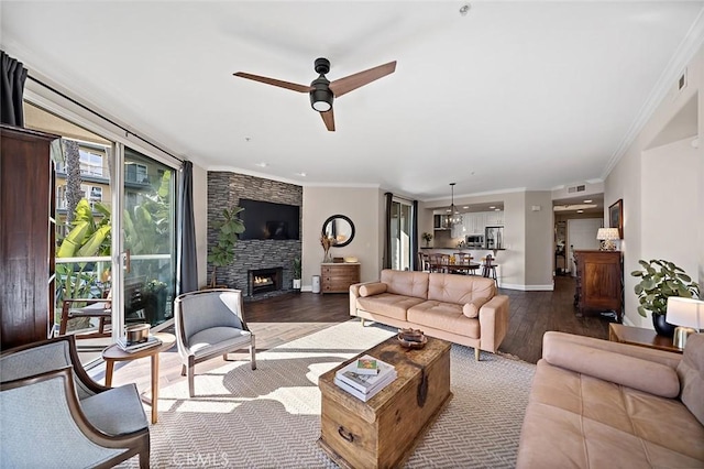 1500 E Ocean Blvd Unit 419, Long Beach, CA 90802 - living area featuring wood finished floors, crown molding, a stone fireplace, ceiling fan, and baseboards