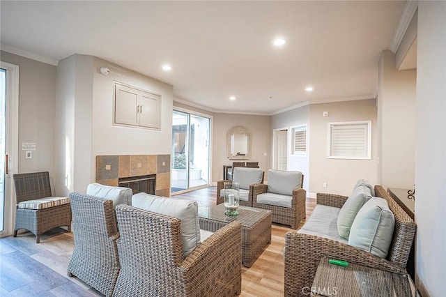1500 E Ocean Blvd Unit 419, Long Beach, CA 90802 - living room featuring light wood-type flooring, recessed lighting, a fireplace, ornamental molding, and baseboards