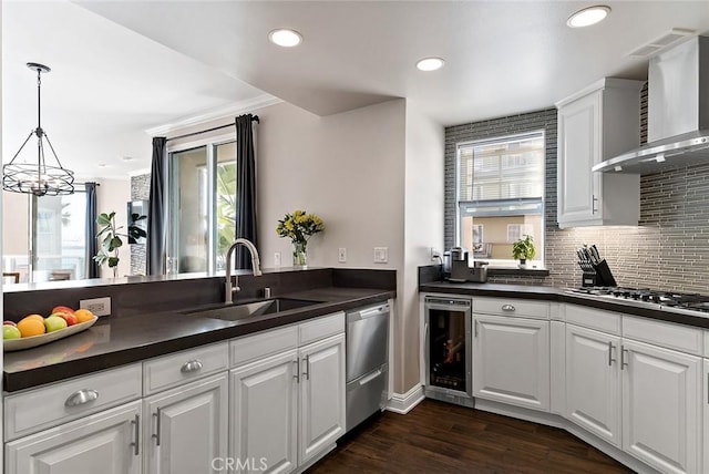1500 E Ocean Blvd Unit 419, Long Beach, CA 90802 - kitchen featuring a sink, wall chimney exhaust hood, stainless steel dishwasher, dark countertops, and recessed lighting
