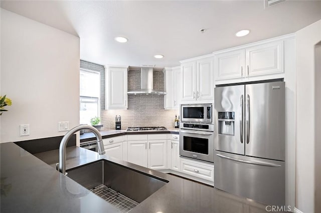 1500 E Ocean Blvd Unit 419, Long Beach, CA 90802 - kitchen featuring appliances with stainless steel finishes, wall chimney exhaust hood, a sink, white cabinets, and recessed lighting