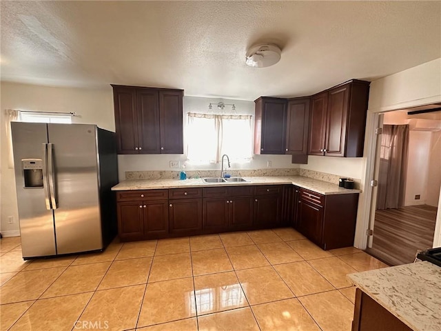 3208 W 74th St, Los Angeles, CA 90043 - kitchen featuring stainless steel fridge, plenty of natural light, a textured ceiling, light tile patterned floors, and dark brown cabinetry