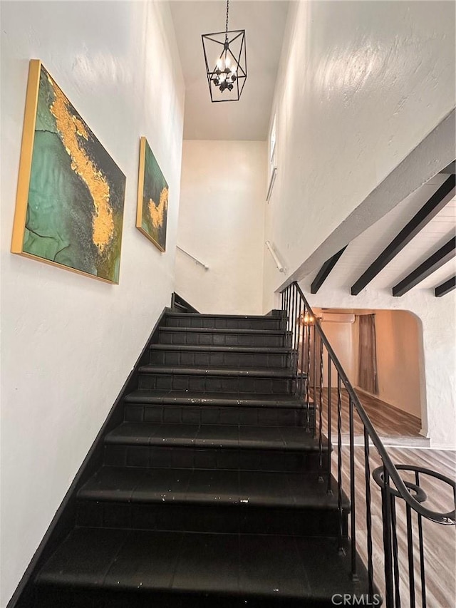 3208 W 74th St, Los Angeles, CA 90043 - stairway featuring a chandelier and beamed ceiling