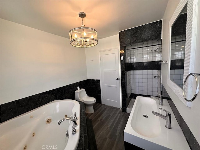 3208 W 74th St, Los Angeles, CA 90043 - bathroom featuring a chandelier, a tub with jets, a stall shower, tile walls, and wood finished floors