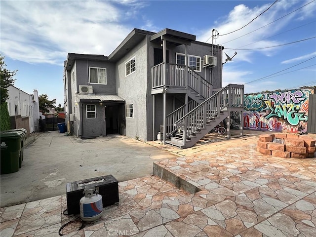 3208 W 74th St, Los Angeles, CA 90043 - back of house with a patio, stairs, stucco siding, and cooling unit