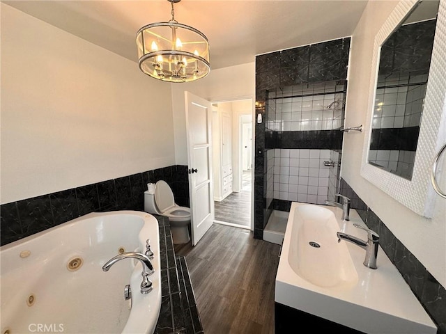 3208 W 74th St, Los Angeles, CA 90043 - bathroom with a whirlpool tub, a shower stall, a chandelier, wood finished floors, and vanity