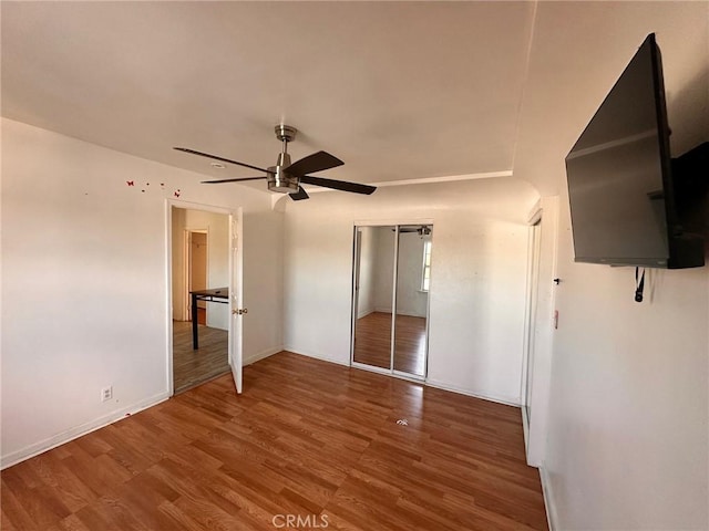 3208 W 74th St, Los Angeles, CA 90043 - unfurnished bedroom with wood finished floors, a closet, and a ceiling fan
