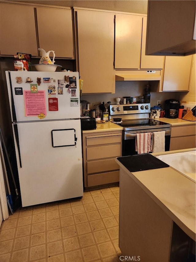 445 Almond Dr Unit 84, Lodi, CA 95240 - kitchen with freestanding refrigerator, stainless steel range with electric stovetop, under cabinet range hood, light countertops, and light floors