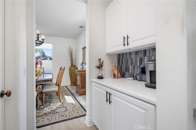 36275 Firelight Cir, Wildomar, CA 92595 - hall with light wood-style floors and a chandelier
