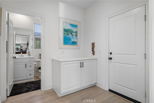 36275 Firelight Cir, Wildomar, CA 92595 - doorway with light wood-style floors and a sink