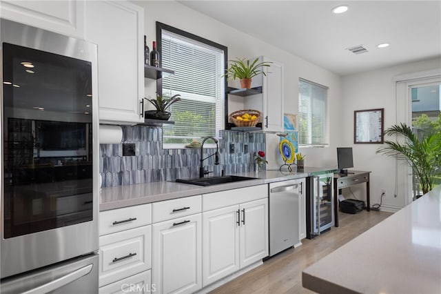 36275 Firelight Cir, Wildomar, CA 92595 - kitchen with open shelves, light wood-style floors, wine cooler, dishwasher, and recessed lighting