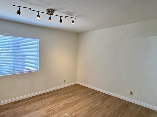428 N Chapel Ave Unit B, Alhambra, CA 91801 - spare room featuring wood finished floors, baseboards, and rail lighting