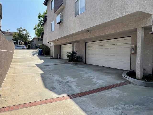 428 N Chapel Ave Unit B, Alhambra, CA 91801 - view of side of property featuring stucco siding, an attached garage, and concrete driveway
