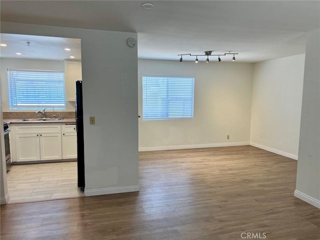 428 N Chapel Ave Unit B, Alhambra, CA 91801 - unfurnished room with a sink, light wood finished floors, plenty of natural light, baseboards, and recessed lighting