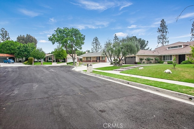 19520 Bermudas St, Porter Ranch, CA 91326 - view of asphalt road with sidewalks, a residential view, and curbs
