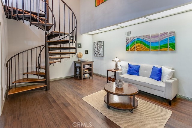 19520 Bermudas St, Porter Ranch, CA 91326 - living area featuring wood finished floors, stairs, a towering ceiling, and baseboards