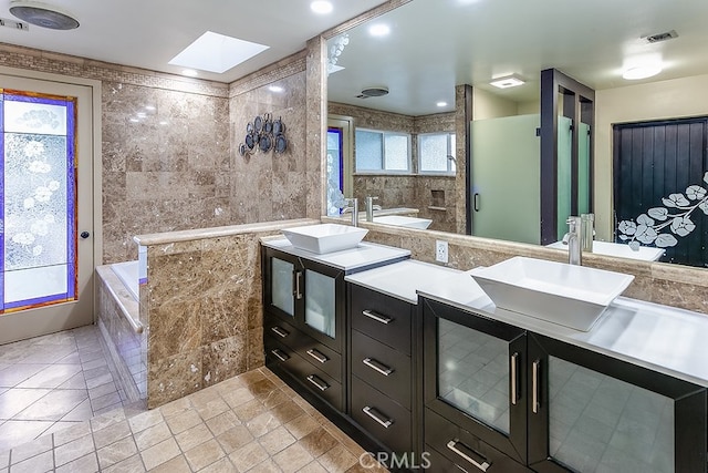 19520 Bermudas St, Porter Ranch, CA 91326 - bathroom with a skylight, double vanity, a garden tub, and a shower stall