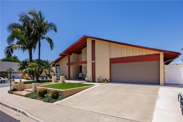 24711 Eloisa Dr, Mission Viejo, CA 92691 - mid-century modern home with an attached garage, driveway, and stucco siding