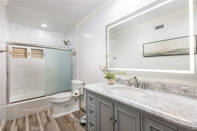 24711 Eloisa Dr, Mission Viejo, CA 92691 - bathroom featuring vanity, toilet, wood finished floors, ornamental molding, and enclosed tub / shower combo