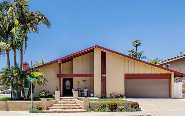 24711 Eloisa Dr, Mission Viejo, CA 92691 - mid-century modern home with a garage, concrete driveway, covered porch, and stucco siding
