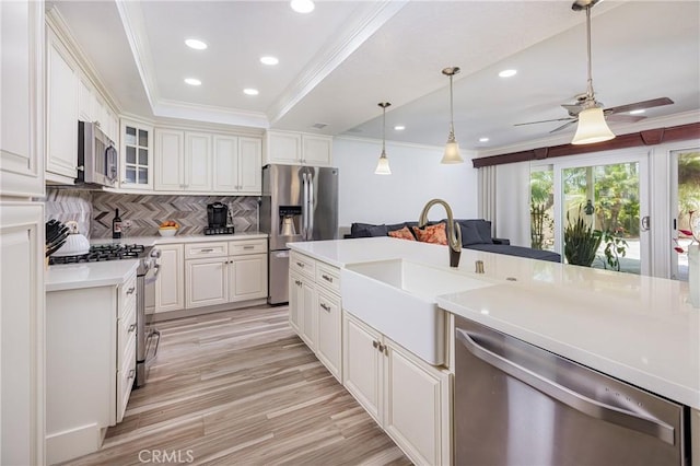 24711 Eloisa Dr, Mission Viejo, CA 92691 - kitchen featuring stainless steel appliances, a sink, ceiling fan, crown molding, and light countertops