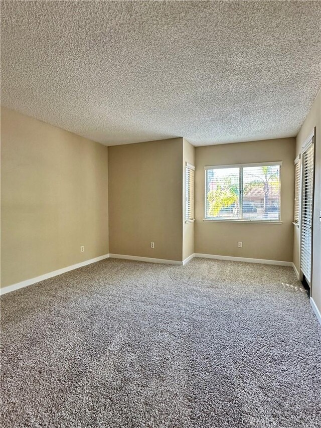 25843 Mcbean Unit 9, Valencia, CA 91355 - carpeted empty room featuring a textured ceiling and baseboards