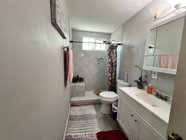 24910 Allesandro, Moreno Valley, CA 92553 - full bathroom featuring a tile shower, toilet, and vanity