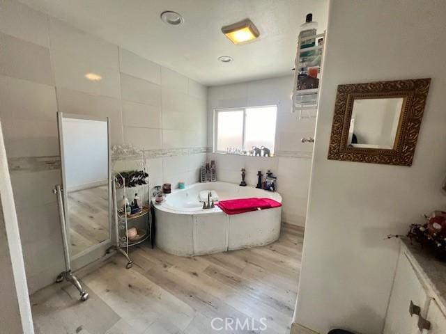 24910 Allesandro, Moreno Valley, CA 92553 - full bathroom featuring wood finished floors, a bath, and tile walls