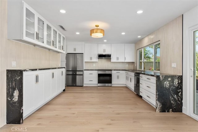 21692 Seaside Ln, Huntington Beach, CA 92646 - kitchen featuring stainless steel appliances, exhaust hood, light wood finished floors, white cabinetry, and recessed lighting