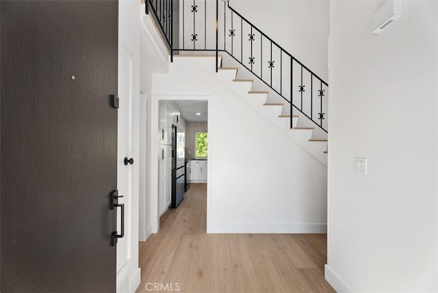 21692 Seaside Ln, Huntington Beach, CA 92646 - stairway featuring wood finished floors, baseboards, and a towering ceiling