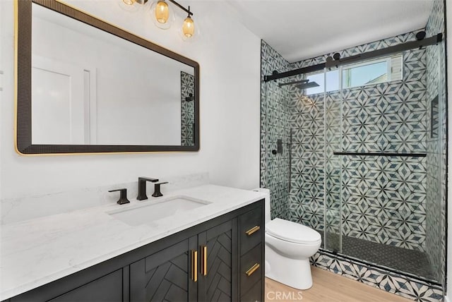21692 Seaside Ln, Huntington Beach, CA 92646 - bathroom featuring toilet, vanity, a stall shower, and wood finished floors
