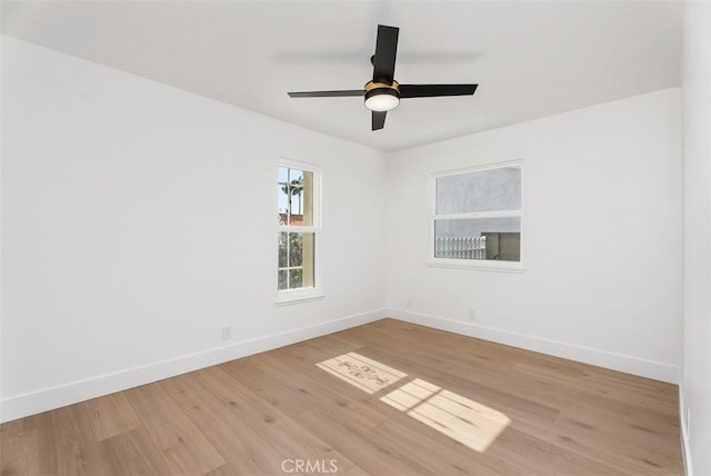 21692 Seaside Ln, Huntington Beach, CA 92646 - unfurnished room with light wood finished floors, baseboards, and a ceiling fan
