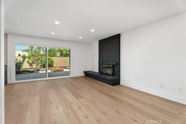 21692 Seaside Ln, Huntington Beach, CA 92646 - unfurnished living room with baseboards, wood finished floors, recessed lighting, and a fireplace