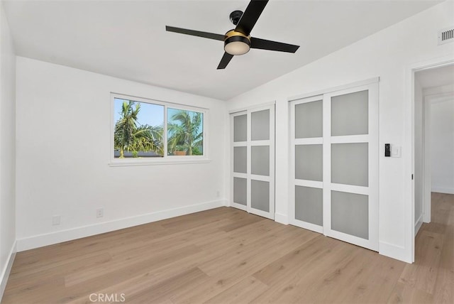 21692 Seaside Ln, Huntington Beach, CA 92646 - spare room with light wood finished floors, vaulted ceiling, a ceiling fan, and baseboards