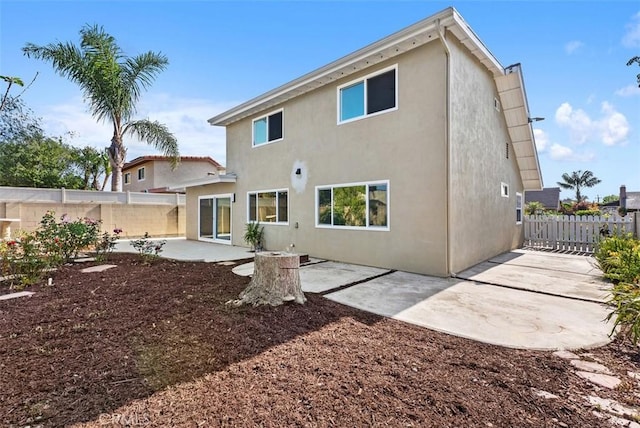 21692 Seaside Ln, Huntington Beach, CA 92646 - back of house with a patio area, stucco siding, and a fenced backyard
