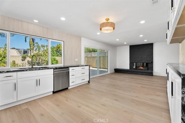 21692 Seaside Ln, Huntington Beach, CA 92646 - kitchen with stainless steel dishwasher, a sink, white cabinetry, light wood finished floors, and recessed lighting