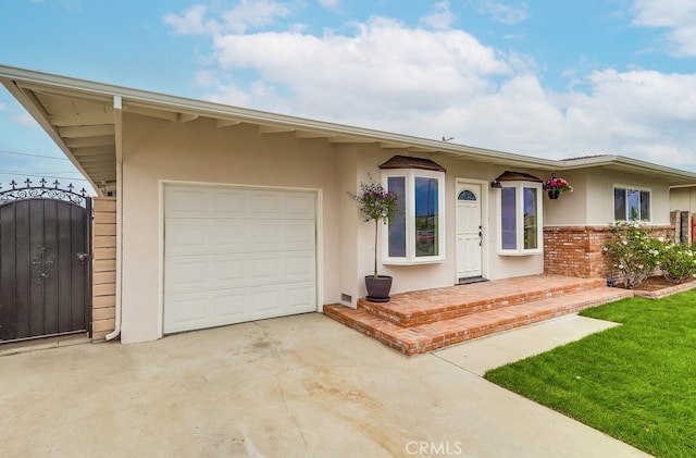 117 E 229th Pl, Carson, CA 90745 - ranch-style house featuring stucco siding, a garage, driveway, and a gate