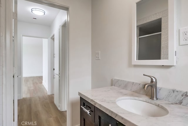 117 E 229th Pl, Carson, CA 90745 - bathroom with vanity, wood finished floors, and an enclosed shower