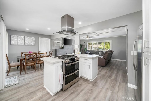 3580 Maricopa Rd, Atascadero, CA 93422 - kitchen featuring stainless steel appliances, island range hood, white cabinetry, light countertops, and ceiling fan