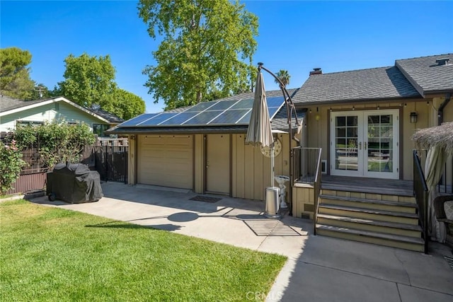 3580 Maricopa Rd, Atascadero, CA 93422 - view of front of property featuring french doors, roof mounted solar panels, concrete driveway, roof with shingles, and a chimney