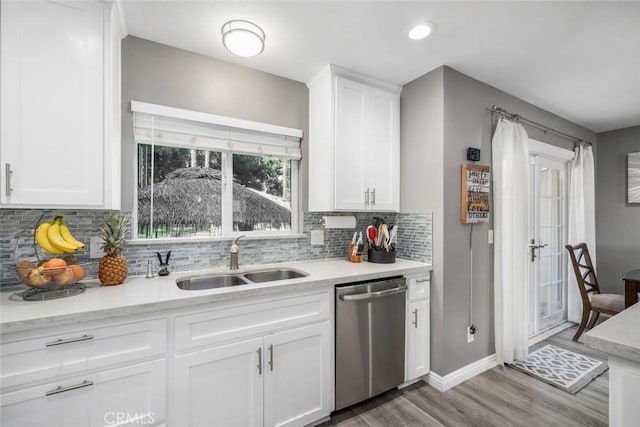 3580 Maricopa Rd, Atascadero, CA 93422 - kitchen with dishwasher, light wood-type flooring, backsplash, light countertops, and white cabinetry