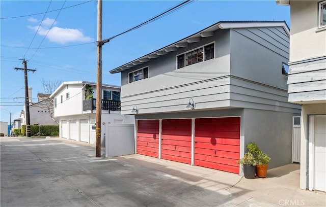 304 Dahlia Pl, Corona Del Mar, CA 92625 - view of home's exterior with stucco siding, a garage, and concrete driveway