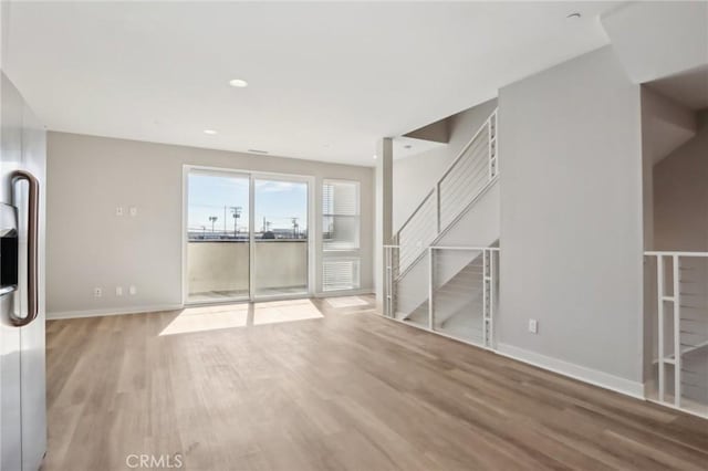 639 Channel Way, Costa Mesa, CA 92627 - unfurnished living room with wood finished floors, baseboards, and stairway