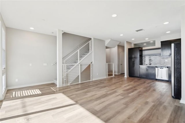 639 Channel Way, Costa Mesa, CA 92627 - unfurnished living room featuring stairs, light wood-type flooring, and recessed lighting
