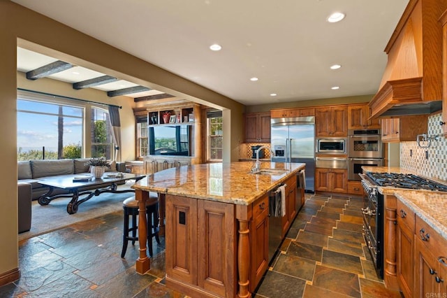 6937 Corte Langosta, Carlsbad, CA 92009 - kitchen featuring built in appliances, brown cabinets, custom range hood, stone tile floors, and recessed lighting