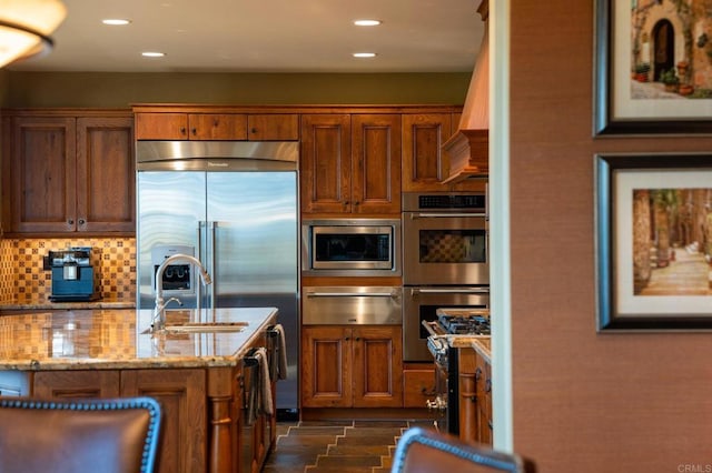 6937 Corte Langosta, Carlsbad, CA 92009 - kitchen with a warming drawer, built in appliances, a sink, backsplash, and brown cabinets