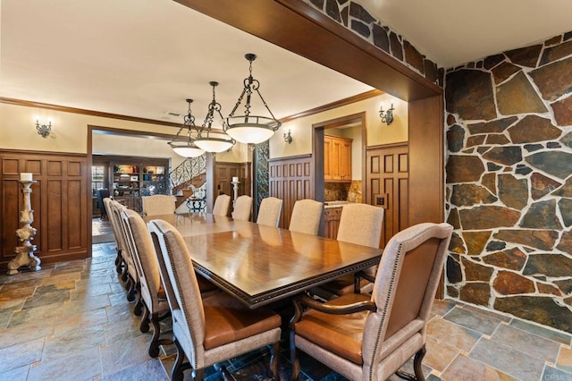 6937 Corte Langosta, Carlsbad, CA 92009 - dining room featuring stone tile floors, ornamental molding, wainscoting, and a decorative wall