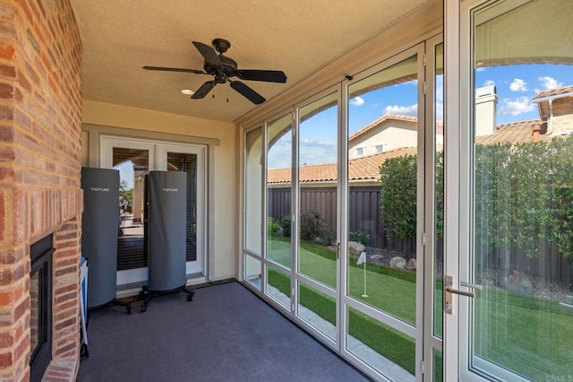 6937 Corte Langosta, Carlsbad, CA 92009 - unfurnished sunroom featuring a ceiling fan, a brick fireplace, carpet flooring, and a textured ceiling