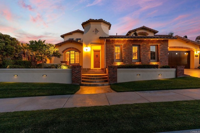 6937 Corte Langosta, Carlsbad, CA 92009 - mediterranean / spanish-style home featuring a yard, a tiled roof, stucco siding, and brick siding