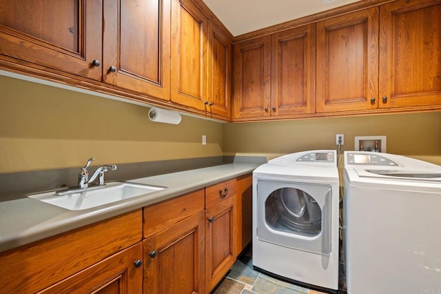 6937 Corte Langosta, Carlsbad, CA 92009 - laundry area featuring cabinet space, washing machine and dryer, and stone finish floors